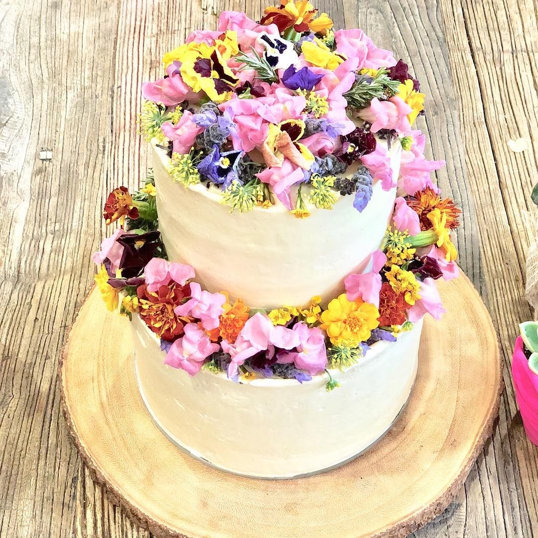 A rustic gluten free birthday cake with all fresh edible flowers.  ...